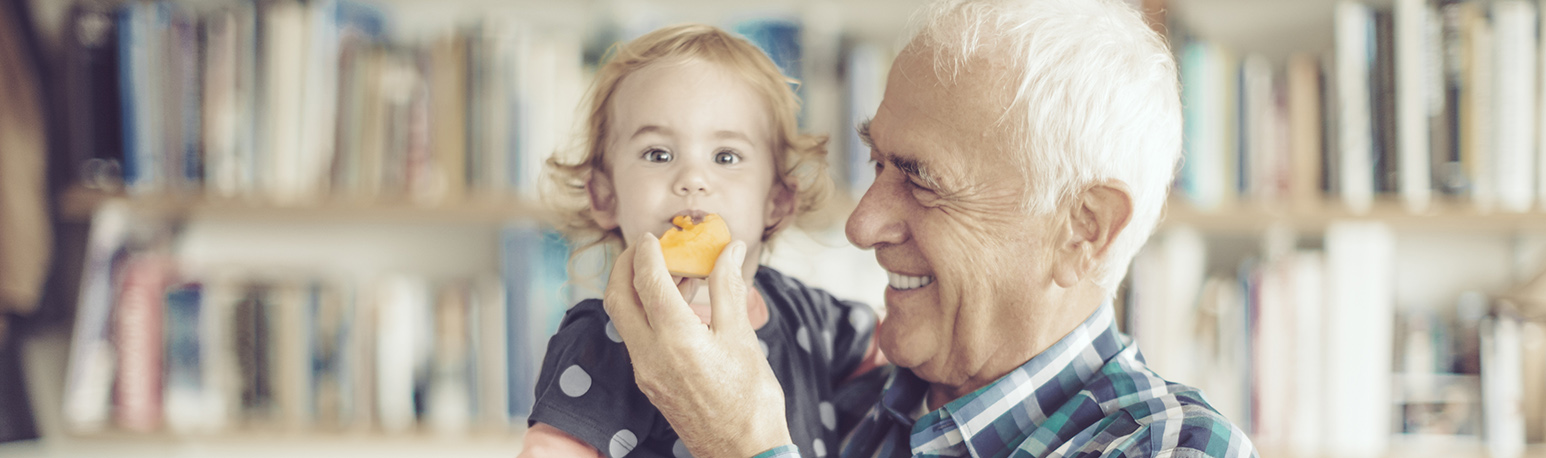 Candid portrait of a happy grandfather and his cute granddaughter.
